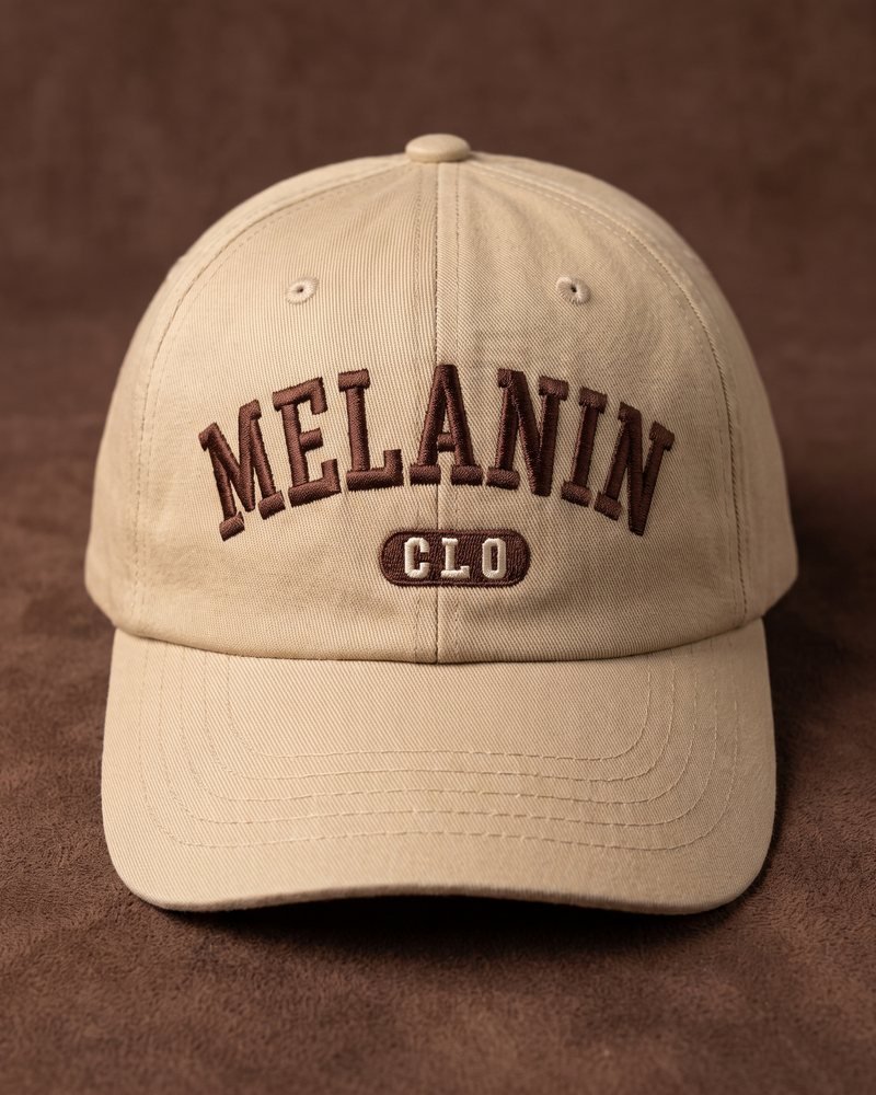 Mockup of the Melanin CLO logo embroidered on a sand-coloured cap