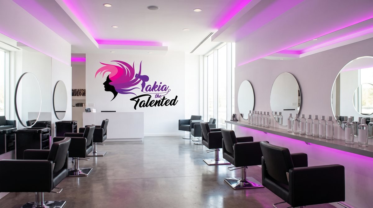 Mockup of the Takia the Talented logo printed large on a salon wall