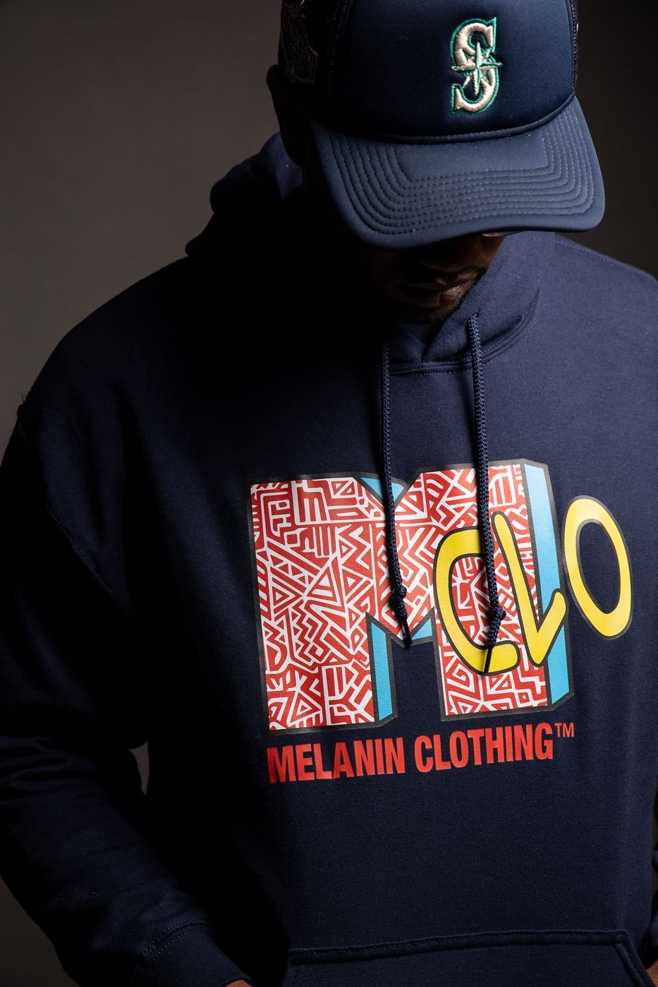 Close crop of the Melanin Clothing graphic print on a navy hoodie