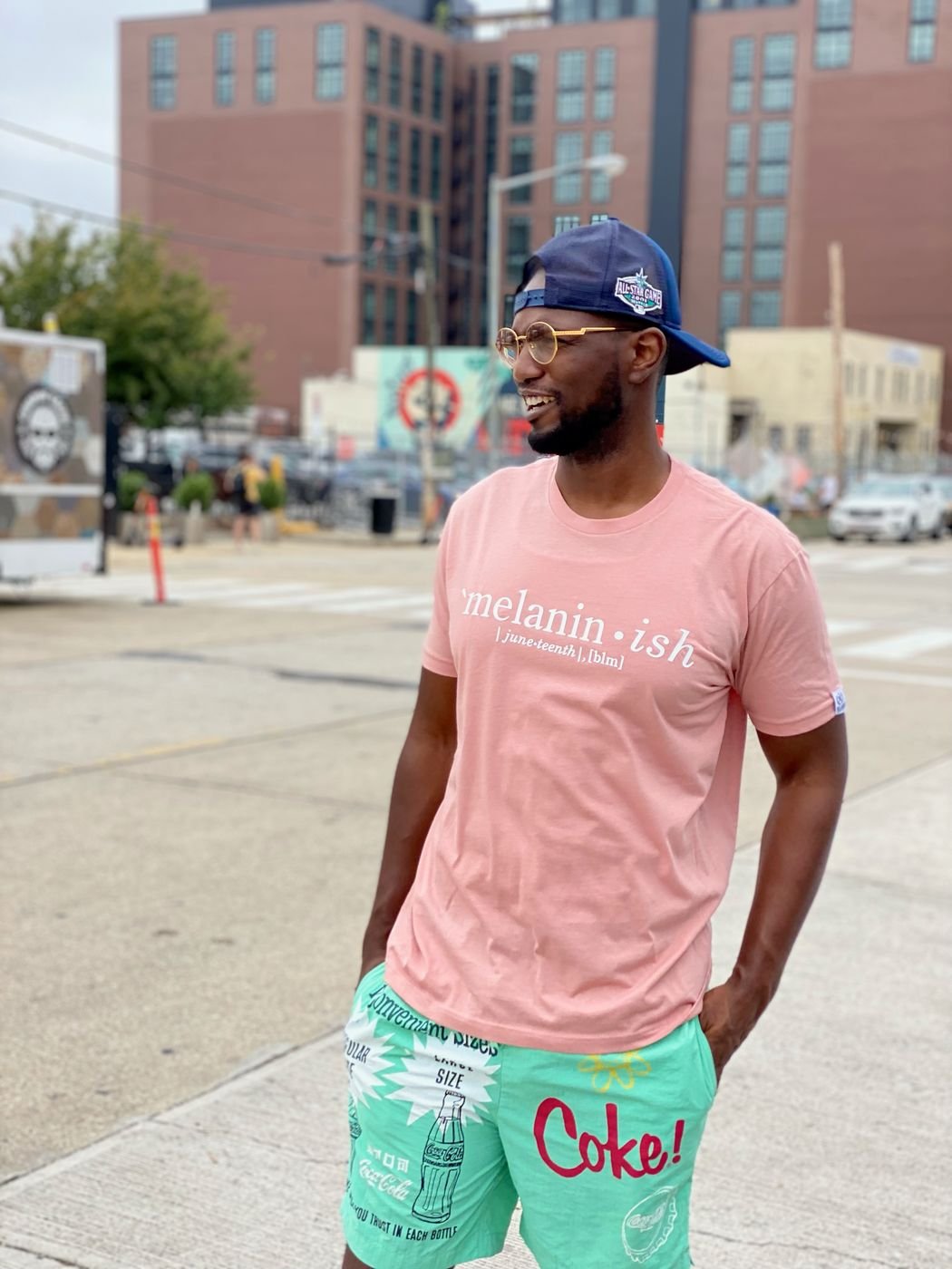 Model in a peach Melanin-ish tee on a city street